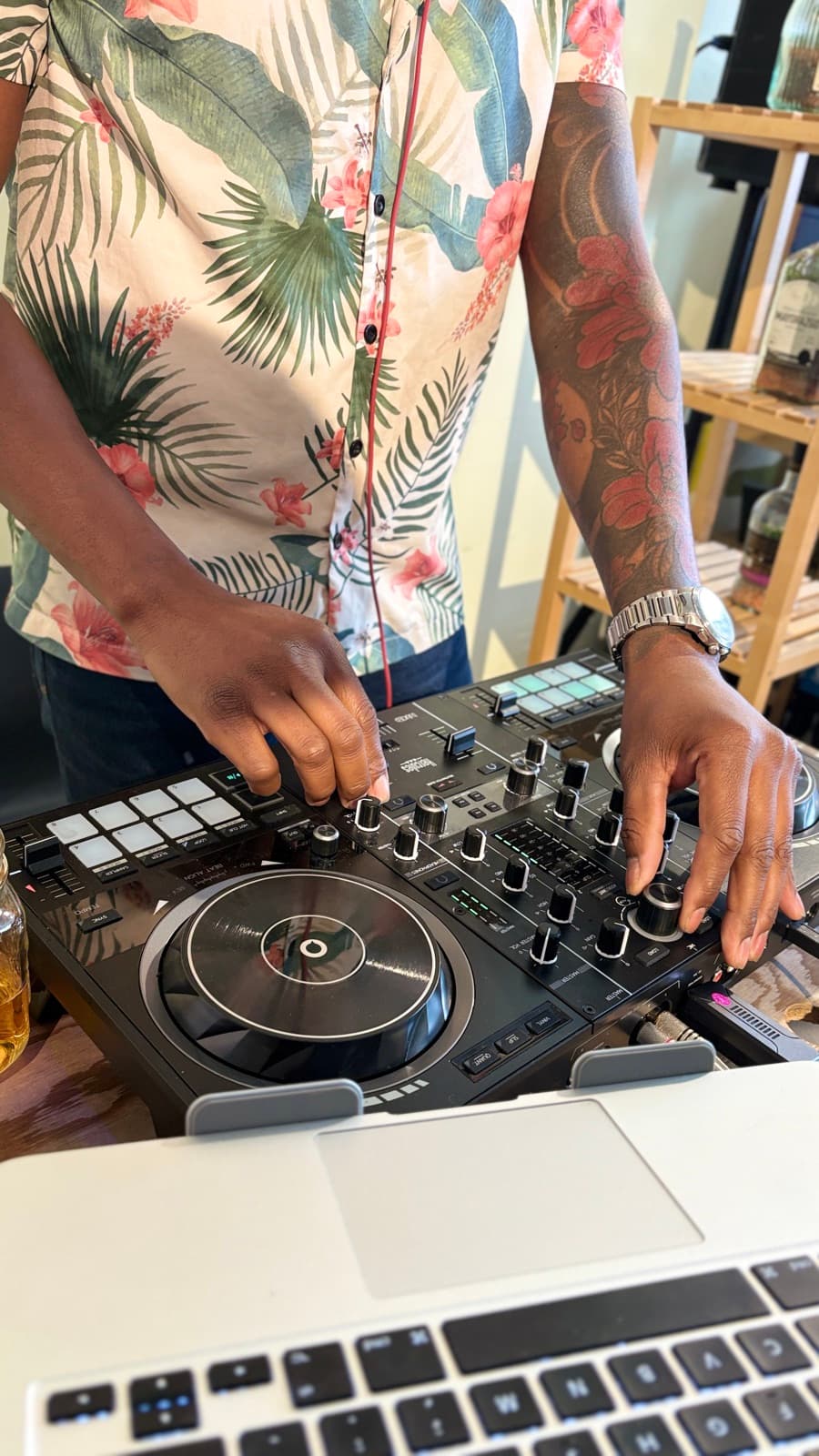 Manos de DJ Kenny mezclando en el controller